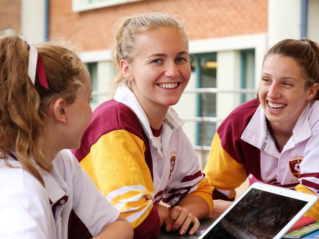 Champion schoolgirl swimmer Ariarne Titmus (centre) back at school with her mates Poppy Brennan (left) and Caitlin Leslie (right) at St Peters Lutheran College in Indooroopilly. Picture: Liam Kidston