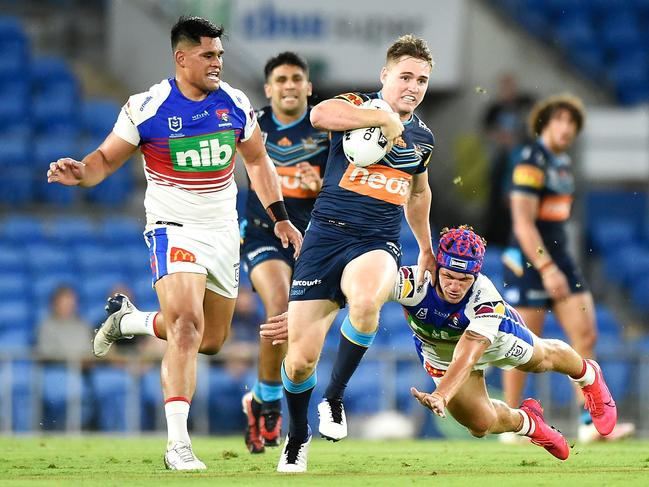 AJ Brimson of the Titans busts through an attempted tackle by Kalyn Ponga on his way to the tryline. Picture: Matt Roberts/Getty Images