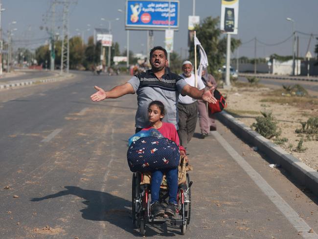 A man reacts as people carrying some of their belongings reach the central Gaza Strip on foot via the Salah al-Din road on their way to the southern part of the Palestinian enclave. Picture: AFP