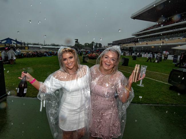 Coralee Thompson 24 and jasmin Kearney 25 Wantirna . 2018 Melbourne Cup, Punters arrive in the rain at Flemington. Heavy rain hits Flemington. Picture: Jason Edwards