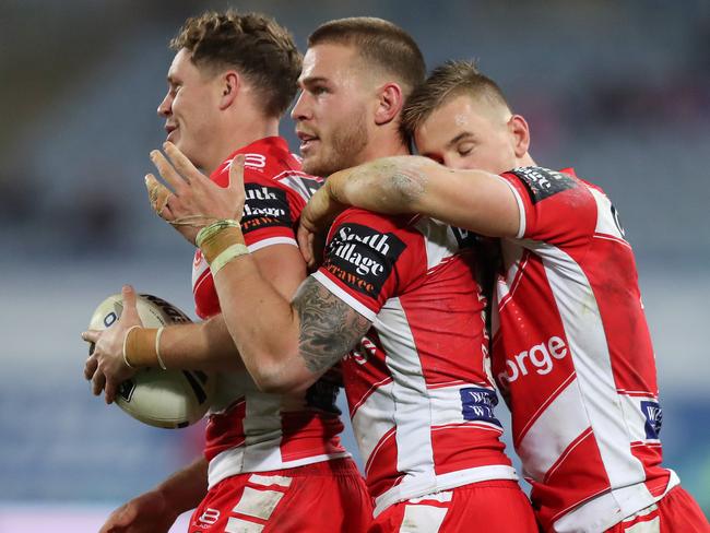 St George's Kurt Mann, Euan Aitken and Matt Dufty celebrate a close victory over the Bulldogs. Picture: Brett Costello