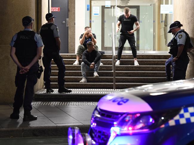 Darling Harbour Multiple Assaults:  EXCLUSIVE: At around 1:40am this morning emergency services responded to reports that five men had assaulted a Security Guard in Pyrmont near the Watershed Hotel. Not long after reports came through of an unprovoked assault of five men against three men in Darling Harbour. One of the victims is believed to have sustained a broken nose. The Offenders ran from the scene with two entering a Taxi on Sussex Street near Druitt, but Police were already onto them stopping them on the Western Distributor on-ramp Police released these two men pending further enquiries. At the same time Police were tracking the other three men as they walked along Kent Street pouncing on them near the corner of Bathurst Street. Police detained and searched the men as they reviewed CCTV of the incident. After a lengthy period one man was arrested and two released. Police are expecting to make more arrests after further investigations. The group of five are believed to be responsible for both assaults in Pyrmont and Darling Harbour. Its not clear at this stage what injuries the Security Officer sustained during this incident. Three men are detained on Kent Street as Police determine their involvement in the assaults. Picture: Gordon McComiskie