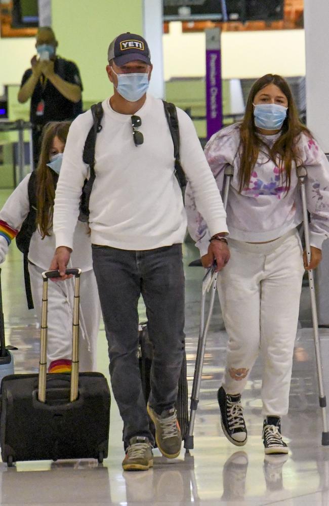 Matt Damon checking in for a commercial flight home to the USA, with two of his daughters. Picture: Media-Mode