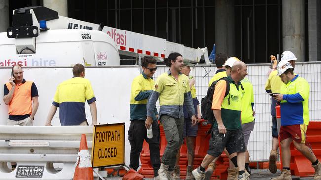 Workers leave the Jewel worksite in Surfers Paradise. Photo: Tertius Pickard