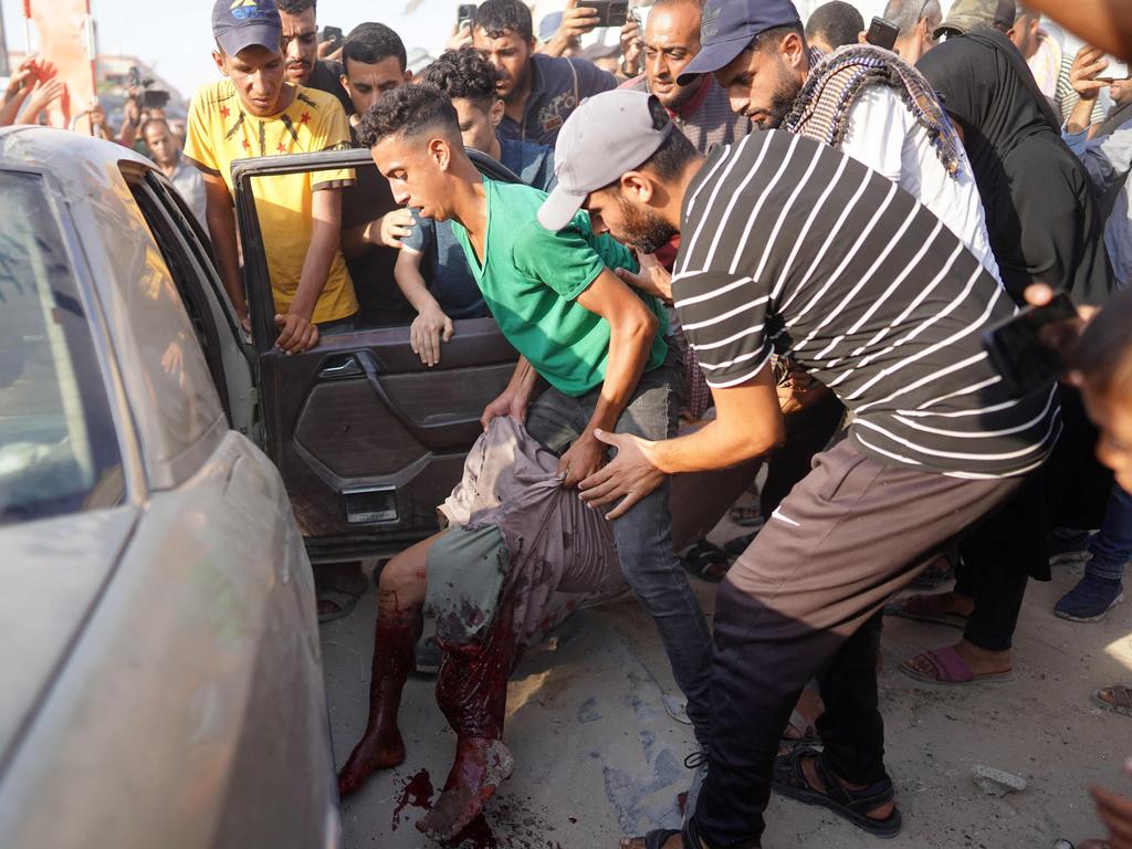 Palestinians evacuate a man wounded after an Israeli strike near the the Nasser Medical Complex in Khan Yunis in the southern Gaza Strip. Picture: AFP