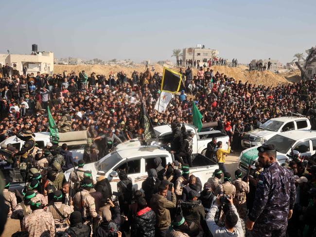 Crowds gather as Palestinian Hamas and Islamic Jihad fighters arrive near the family home of slain Hamas leader Yahya Sinwar, where the Hamas militant group prepares to hand over Israeli and Thai hostages to a Red Cross team in Khan Yunis. Picture: AFP