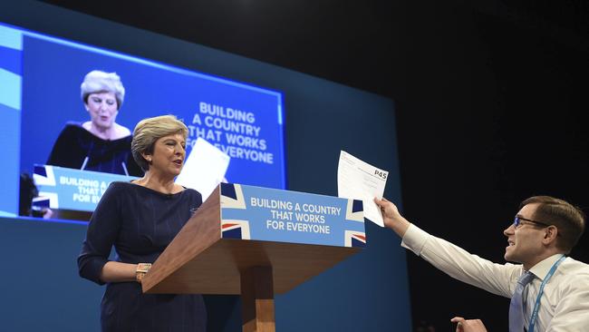 Comedian Simon Brodkin, also known as Lee Nelson confronts British Prime Minister Theresa May during her keynote speech.