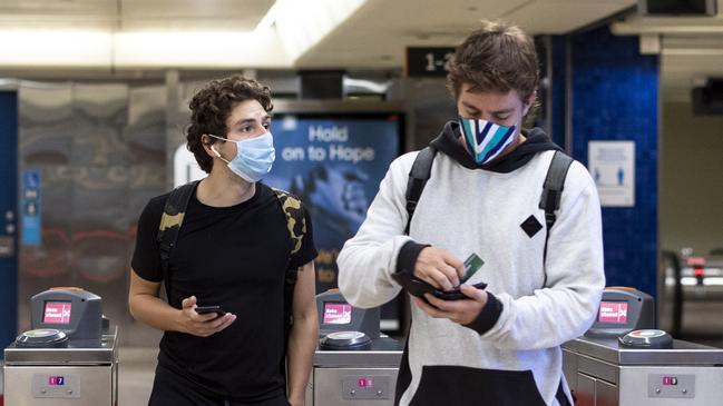 People wearing masks at Edgecliff Station on Tuesday. Picture / Monique Harmer