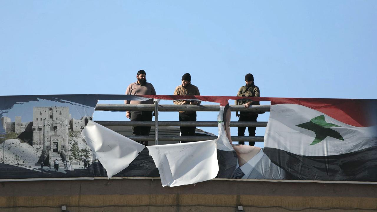 Anti-government fighter look down from a bridge in Aleppo. Picture: AFP