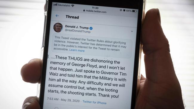 US President Donald Trump's infamous tweet is displayed on a mobile phone. It now features a warning from Twitter. Picture: AFP