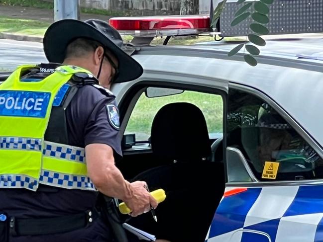 Police on the Gold Coast with a person who allegedly failed a roadside breath test.