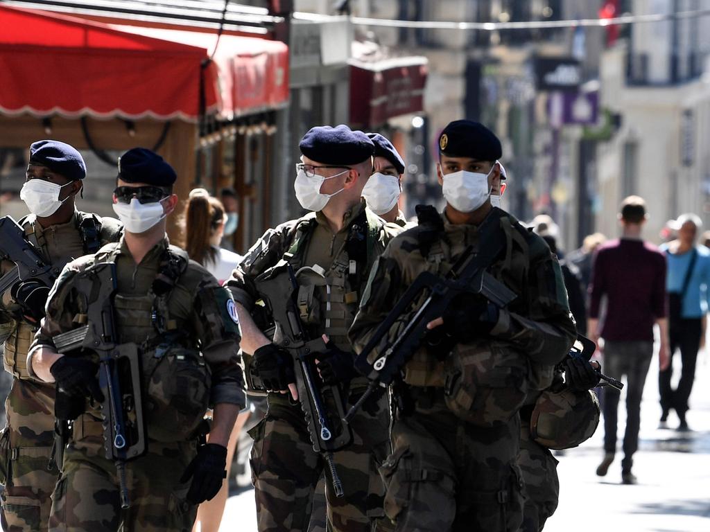 French soldiers from the Sentinelle security operation, wearing protective face masks, patrol on the Champs-Elysees after France eased lockdown measures. Picture: AFP