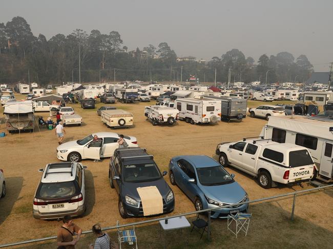 Worried Batemans Bay residents camp in their cars by the beach. Picture: John Grainger