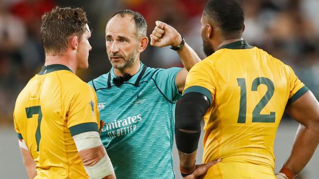 Australia's flanker Michael Hooper (L) and Australia's centre Samu Kerevi (R) listen to French referee Romain Poite (C)   during the Japan 2019 Rugby World Cup Pool D match between Australia and Wales at the Tokyo Stadium in Tokyo on September 29, 2019. (Photo by Odd ANDERSEN / AFP)