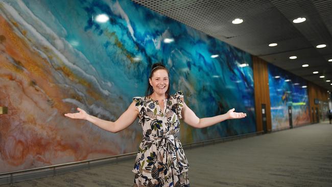 Local artist Brenda Stone's in front of her abstract resin artwork at the Townsville airport. Picture: Shae Beplate.