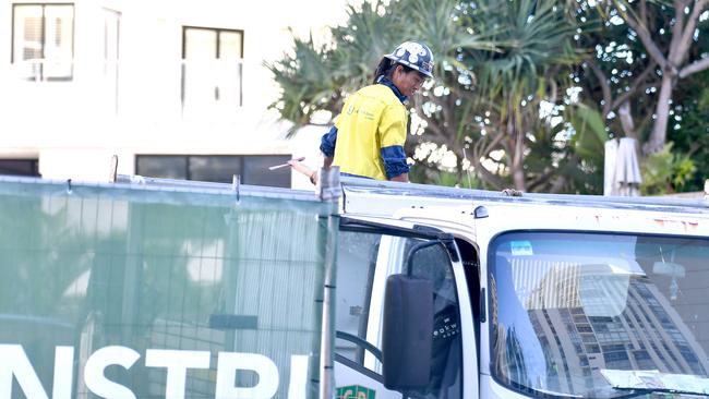 A worker removing scaffolding from the Drift Main Beach site on Monday afternoon. Picture: John Gass