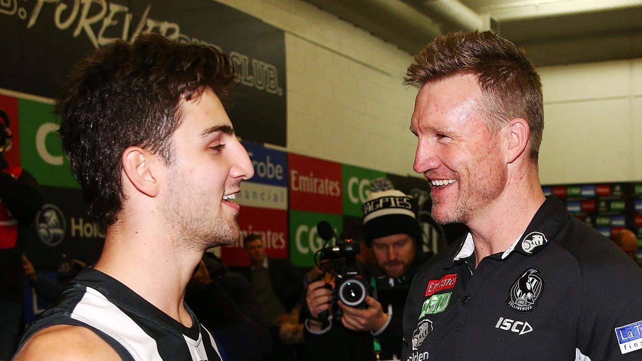 Josh Daicos and Nathan Buckley celebrate the Pies’ win against North Melbourne.
