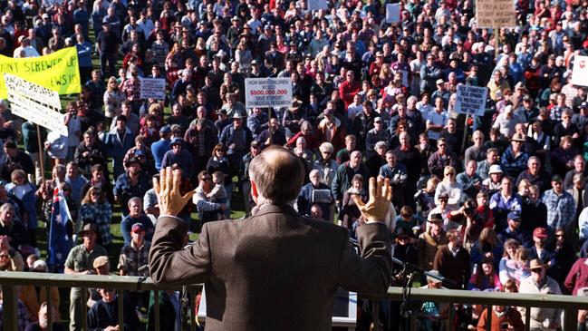 Then-prime minister John Howard, wearing what appears to be bullet proof vest under his suit jacket, fronts up at a hostile pro-gun rally to make the case for gun reform in Sale, Victoria. Picture: Ray Strange