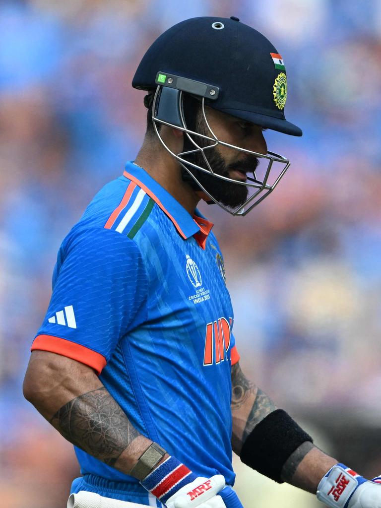 Virat Kohli walks back to the pavilion. (Photo by Punit PARANJPE / AFP)