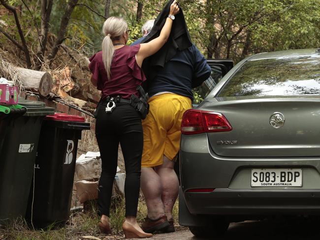 Detectives with Peter Dansie at his Waterfall Gully property, after the discovery of his wife’s body. Picture: Tait Schmaal