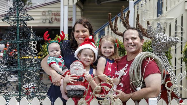 Ray and Christine Robertson with their children Fletcher, Charity and Poppy setting up their lights at their Grange home. Picture: AAP Image/Josh Woning