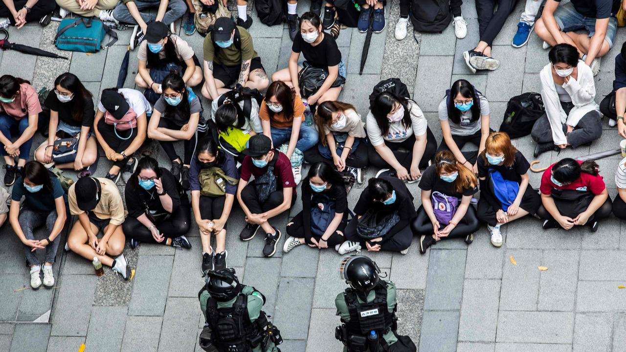 Riot police detain a group of people during a protest in the Causeway Bay district of Hong Kong on May 27, 2020. Picture: Isaac Lawrence/AFP.