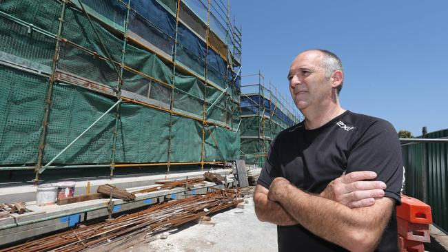 John Rooney pictured in front of his apartment being built in the Waterford apartments complex under construction in Bundall in 2014. The project is now complete. Picture Mike Batterham