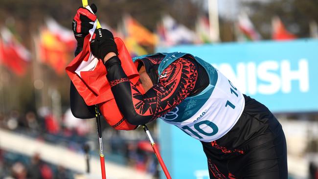 Tonga's Pita Taufatofua crosses the finish line during the men's 15km cross country freestyle. Photo: AFP