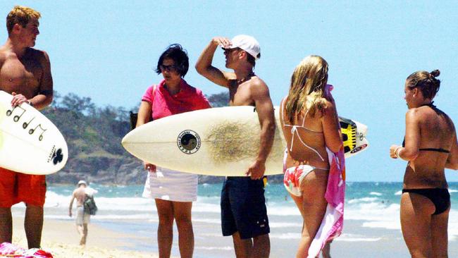 Prince Harry, centre with surfboard, at Noosa Beach during his Australian gap year in 2003.