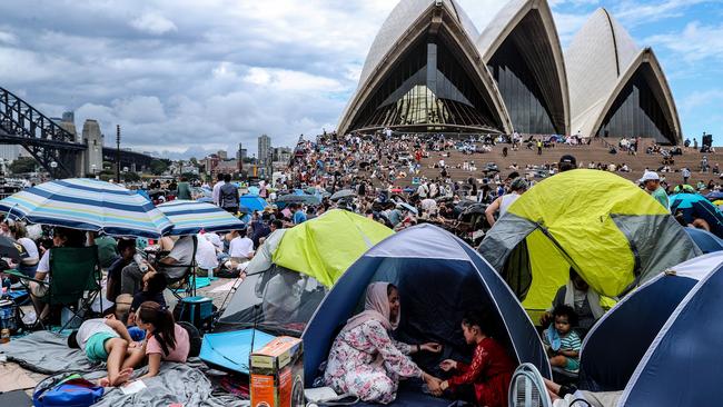 Early arrivals brought tents and umbrellas to shield themselves from the rain while reserving their spot on the Opera House forecourt. Picture: Getty