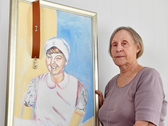 Jan Benson with a painting and the strap that was used to hold her to the bed. Picture: Patrick Woods