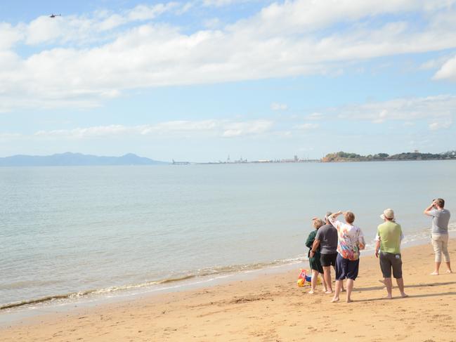 Friends watch on as the helicopter Rhys McCully and Victoria Twivey are in flies over.