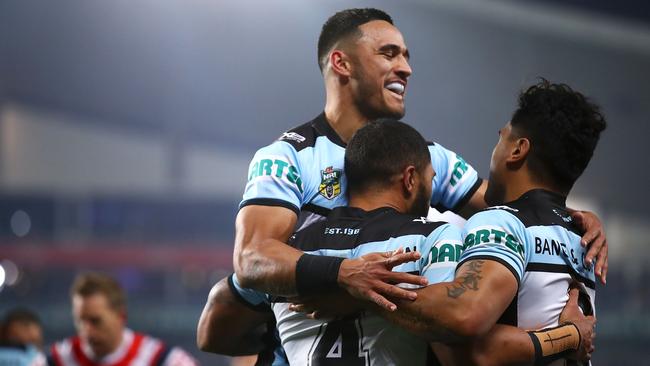 SYDNEY, AUSTRALIA - SEPTEMBER 08: Valentine Holmes and Ricky Leutele of the Sharks celebrate with Sosaia Feki of the Sharks after he scored a try during the NRL Qualifying Final match between the Sydney Roosters and the Cronulla Sharks at Allianz Stadium on September 8, 2018 in Sydney, Australia. (Photo by Mark Kolbe/Getty Images)