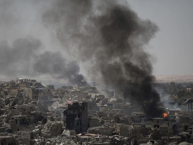 Smoke billows after air strikes hit Islamic State positions on the edge of the Old City a day after Iraq's prime minister declared “total victory” in Mosul last week. Picture: Felipe Dana/AP