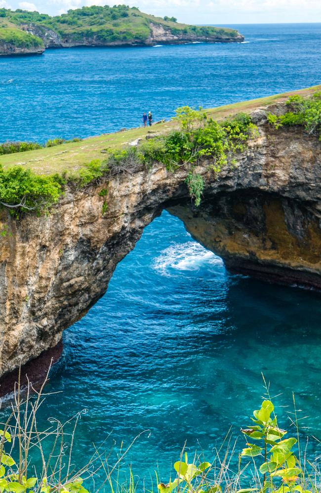 Local police said a tour guide was taking photos of the man at the popular tourist destination before his stunt backfired.