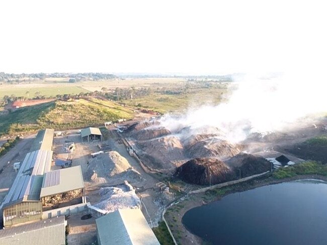 STILL SMOULDERING: AT the Lismore Recycling and Recovery Centre, 10m high piles of compost are still burning five days after a fire burned down the material recovery facility on Sunday August 11.