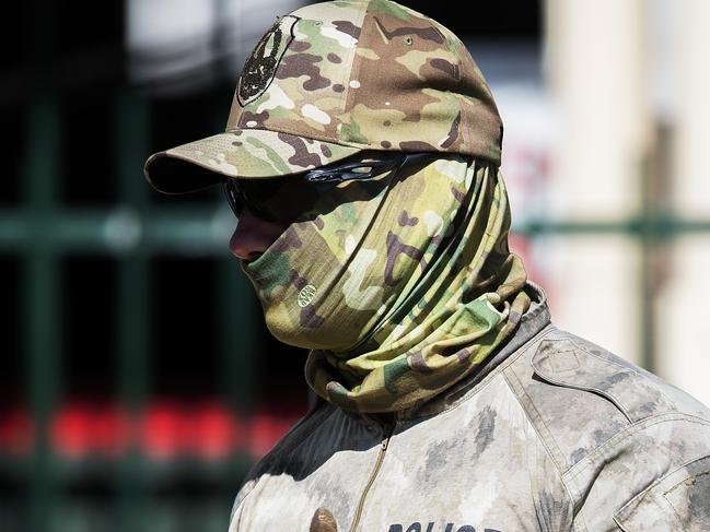 Tactical Response Group officer is seen leaving the Mash Suites  in Darwin CBD, Tuesday, July 16, 2019. Police and health department staff spent almost 20 hours at the building before he was taken into the care of paramedics. Picture: KERI MEGELUS