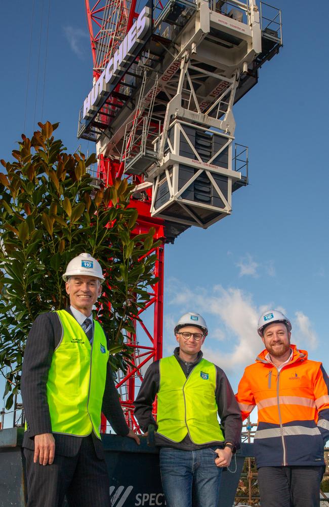 Minister Guy Barnett, Senior Project Manager for Hutchinson Builders Mark Dawson, and CEO of Master Builders Matthew Pollock observe the hoisting of a tree to signify that the building has reached its final height on top of the new $65 million Novotel on Macquarie street in Hobart CBD on 19th June 2023. Picture: Linda Higginson.