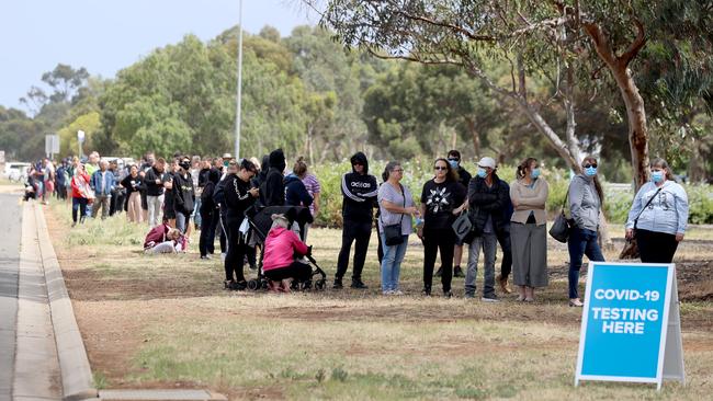 People queuing at the COVID-19 Testing site at Parafield Airport on Monday after 17 new coronavirus cases. The new community cases have been linked to a COVID-19 cluster in Adelaide's northern suburbs. Picture: Kelly Barnes/Getty Images