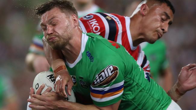 Canberra's Elliott Whitehead might have scored if not for the Roosters’ trainer’s head getting in the way. Picture: Brett Costello