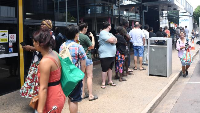 People lining up at Centrelink in Darwin CBD after the COVID lockdown was announced in March. PICTURE: KATRINA BRIDGEFORD