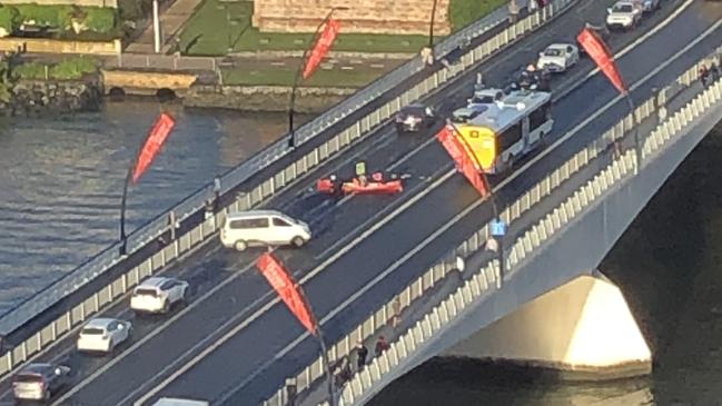 A canoe stops traffic on the Victoria Bridge in the Brisbane CBD.