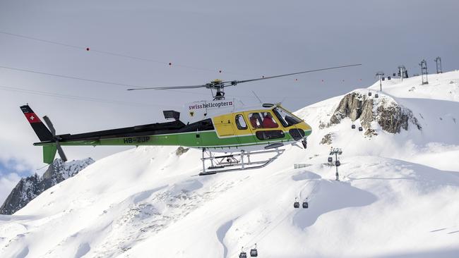 Rescue forces and helicopters search for missing people after an avalanche swept down a ski piste in the central town of Andermatt, Switzerland. Picture: AP