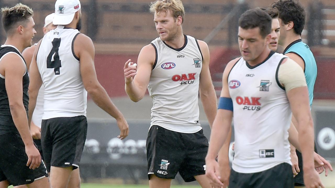 Port Adelaide’s Tom Rockliff, right, wears the blue leadership armband at training at Alberton on Wednesday. Picture: Naomi Jellicoe