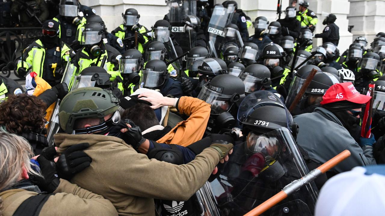 Riot police tried to push back the crowd as they stormed the Capitol building. Picture: Roberto Schmidt/AFP