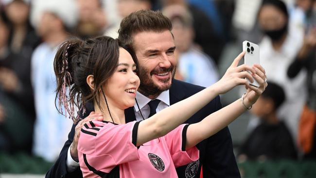 Hong Kong singer Gloria Tang takes a selfie with David Beckham. Picture: AFP