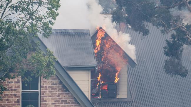 A Northmead home on Whitehaven Road caught fire after a nearby bushfire spread rapidly in Sydney, NSW. Picture: NCA NewsWire / James Gourley