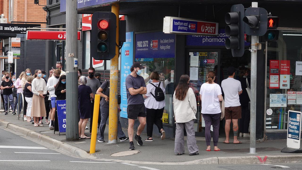 A large queue of people outside a Hawthorn East pharmacy lining up for Rapid Antigen Tests. Picture: Alex Coppel