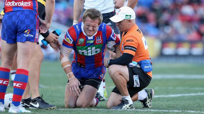 Knights fullback Nathan Ross is helped off the field.