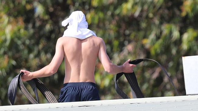 A youth with a fire house on roof of the Parkville detention centre. Picture: Alex Coppel